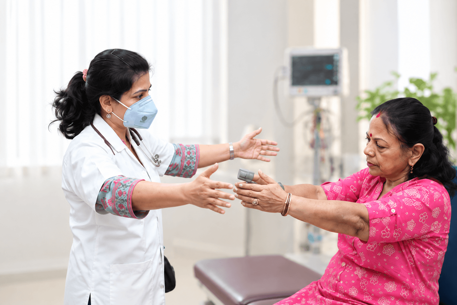 A physiotherapist supporting a patient through an arm movement